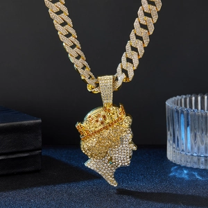 Close-up of hip hop crown pendant with full rhinestones and golden cuban link chain