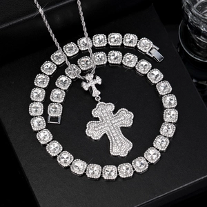 Macro view of silver cross pendant and tennis chain with shimmering white zircons