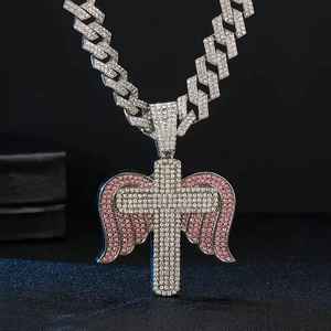 Iced out hip hop cross pendant with pink angel wings on a sparkling cuban chain