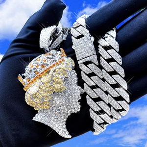 Detailed close-up of hip hop queen portrait pendant iced out with white and yellow crystals