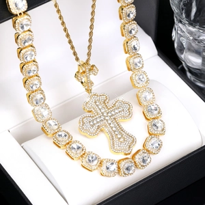 Close-up of hip hop gold cross pendants with iced out rhinestones on tennis chain