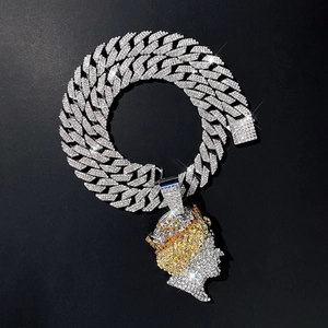 Macro shot of silver hip hop Cuban chain and iced out crown king pendant with zircon