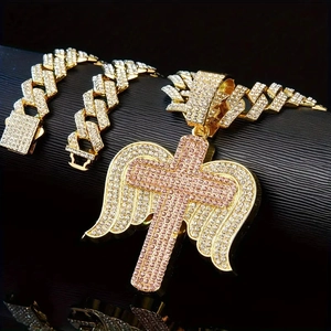 Detailed close-up of hip hop angel wing cross pendant with pink stones on Cuban link chain