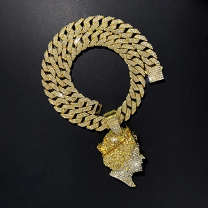 Close-up of iced out hip hop queen portrait pendant and wide Cuban chain with white zircons
