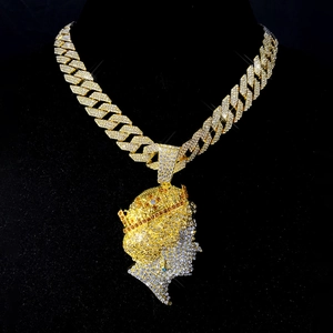 Detailed view of hip hop gold necklace with iced-out queen pendant on black neck bust