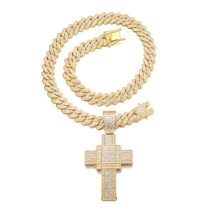 Close-up of hiphop gold Cuban chain and large iced-out cross pendant with white crystals