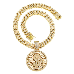 Détail du pendentif hip hop en or avec signe dollar serti sur une grosse chaîne cubaine