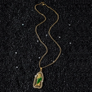 Saint Jude gold religious necklace with green enamel and white zircon stones on black sand