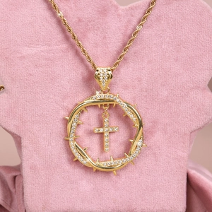 Detailed view of hiphop gold thorn wreath pendant with sparkling crystals and cross charm
