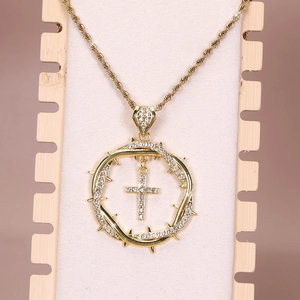 Detailed view of hip hop cross pendant with thorn crown circle and iced out rhinestones