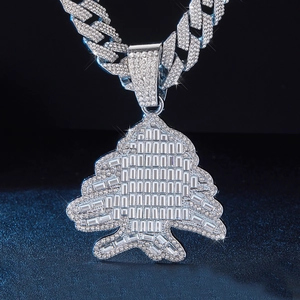 Gros plan du pendentif cèdre argenté serti de diamants sur une grosse chaîne cubaine