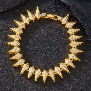 Hip-hop style golden spiked necklace with crystal rhinestones on a dark textured background