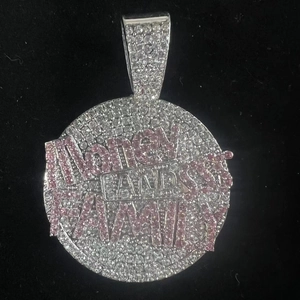 Macro view of iced out silver round pendant with pink Money Bands Family zircon letters