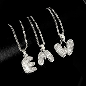 Iced out bubble letter pendants on silver rope chains featuring E, M, and W alphabet charms