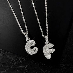 Detailed macro of C and F bubble letters set with sparkling cubic zirconia on rope chain