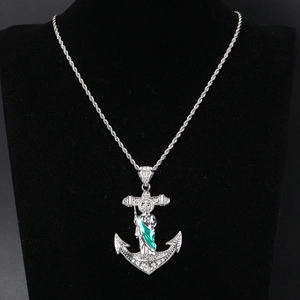 Silver anchor pendant necklace with green saint figure and sparkling crystals on twist chain