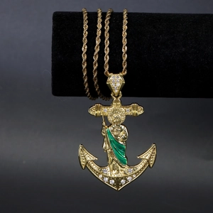 Macro detail of gold Saint Jude anchor cross pendant with crystals and rope chain