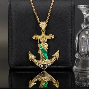 Iced out gold anchor St. Jude pendant with green enamel on a rope chain necklace