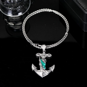 Detail view of silver anchor pendant with Saint Jude figure and rope chain