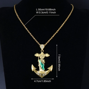 Detail of San Judas Tadeo gold anchor pendant with green enamel on rope chain