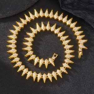 Macro shot of gold hip-hop spike chain necklace with iced-out pave rhinestones