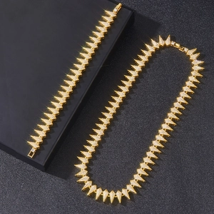 Close-up of golden hip-hop spike necklace and bracelet set with sparkling rhinestones