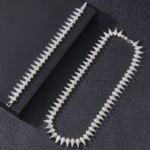 Close-up of silver-toned hip hop spiked jewelry set featuring micro-pave rhinestones