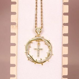 Gold hip hop necklace with iced-out thorn wreath and cross pendant on a rope chain