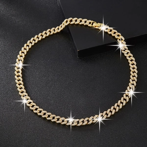 Close-up of golden Cuban chain necklace with sparkling double row rhinestones detail