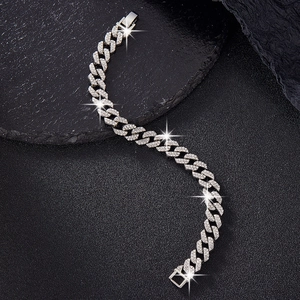 Macro detail of silver cuban link bracelet with double row diamonds and safety clasp