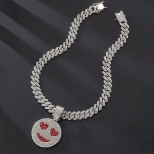 Macro shot of silver Cuban link chain with iced-out smiley face heart-eye pendant