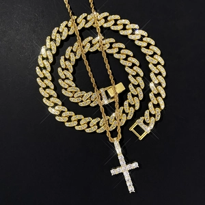 Detail of gold Cuban link chain and iced-out cross pendant with sparkling crystals