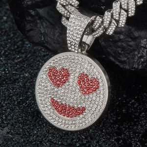 Iced out emoji heart eyes pendant with silver cuban chain on black stone background