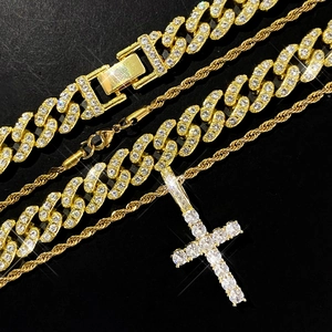 Detail of gold Cuban link chain and cross pendant with iced-out sparkling crystals