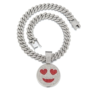Cuban chain necklace with rhinestone heart-eye smiley face pendant on white background