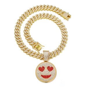 Close-up of iced-out Cuban link chain featuring a red heart-eyed smiley face pendant