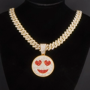 Iced out gold Cuban link necklace featuring a sparkling heart eye smiley face pendant