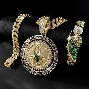 Macro shot of gold hip hop pendant set with sparkling zircons and green enamel accents