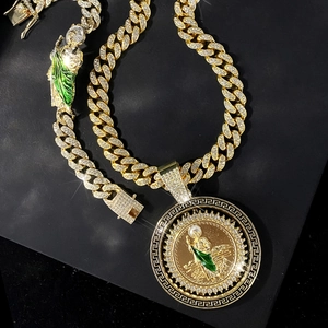 Detail of hip hop gold necklace and bracelet with St. Jude green enamel and crystals