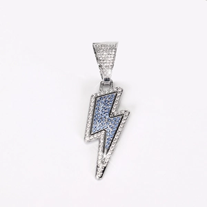 Macro view of hip hop lightning pendant with pavé set white and blue rhinestones