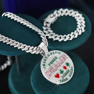 Detail of hip-hop full diamond poker pendant and Cuban link chain set on velvet