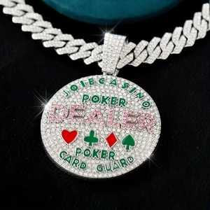 Hiphop iced-out round pendant with dealer letters and Cuban chain in macro view
