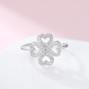Sparkling 925 sterling silver four-leaf clover ring with heart shaped diamond accents