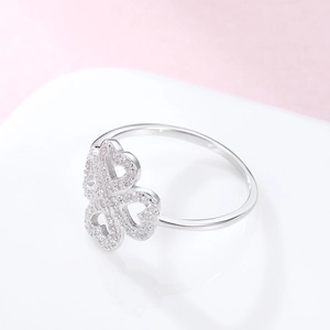 Macro shot of 925 silver four-leaf clover ring with sparkling zircon heart-shaped petals