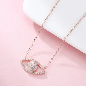 Makroaufnahme der Evil Eye Halskette in Roségold mit Zirkonia auf rosa Hintergrund