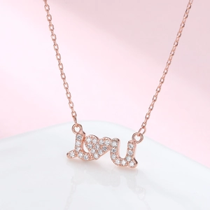 925 silver LOVE U necklace in rose gold with sparkling pavé zircons on pink background