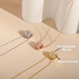 Detail of S925 sterling silver cylinder pendants with layered rectangular and round zircons