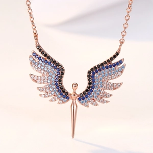 Close-up of rose gold angel wing necklace with blue gradient micro-pave crystals