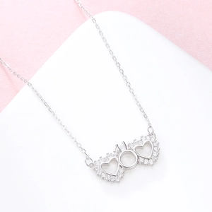 Elegant S925 sterling silver necklace featuring double hollow hearts and zircon pendant