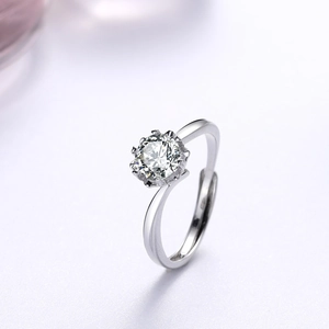 Macro shot of silver snowflake ring featuring a round brilliant moissanite in crown setting